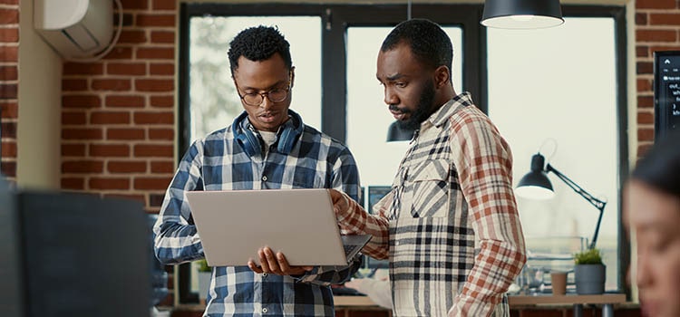 tech intern consults with lead developer